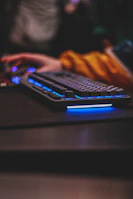 Close-up of a gamer’s hands on a keyboard and mouse, immersed in gameplay.