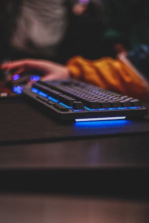 Close-up of hands on a computer keyboard and mouse, highlighting gaming action.