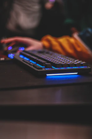 Close-up of a gamer’s hands on a keyboard and mouse, immersed in gameplay.