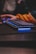 Close-up of a gamer’s hands on a keyboard with Diablo 3 artwork in the background.