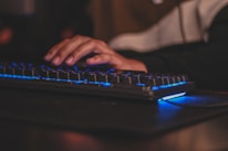 Close-up of hands typing on a keyboard with a glowing chat icon overlay.