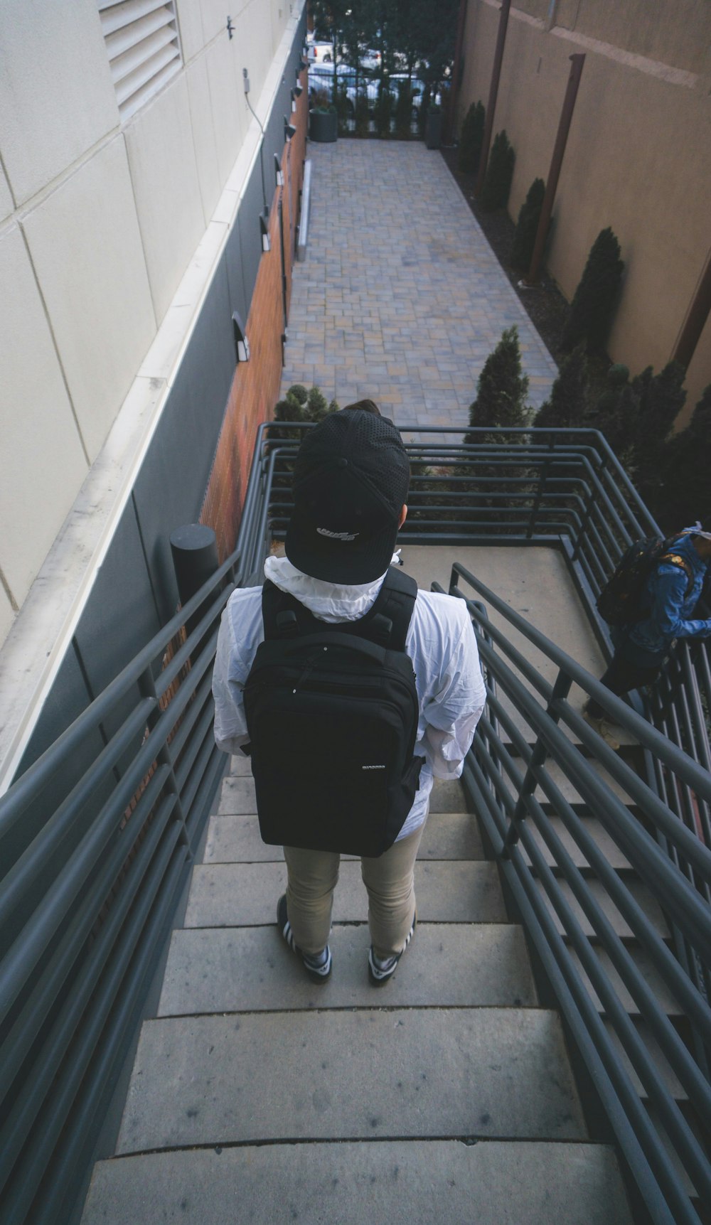 man standing on concrete stairs going down