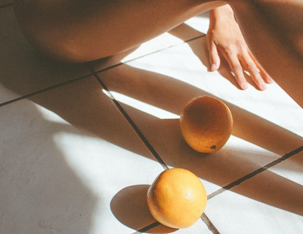 two orange fruits on floor