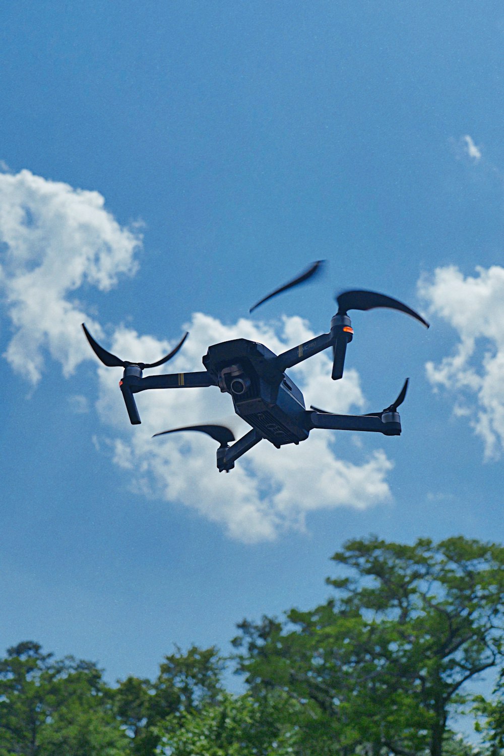 flying drone near tree