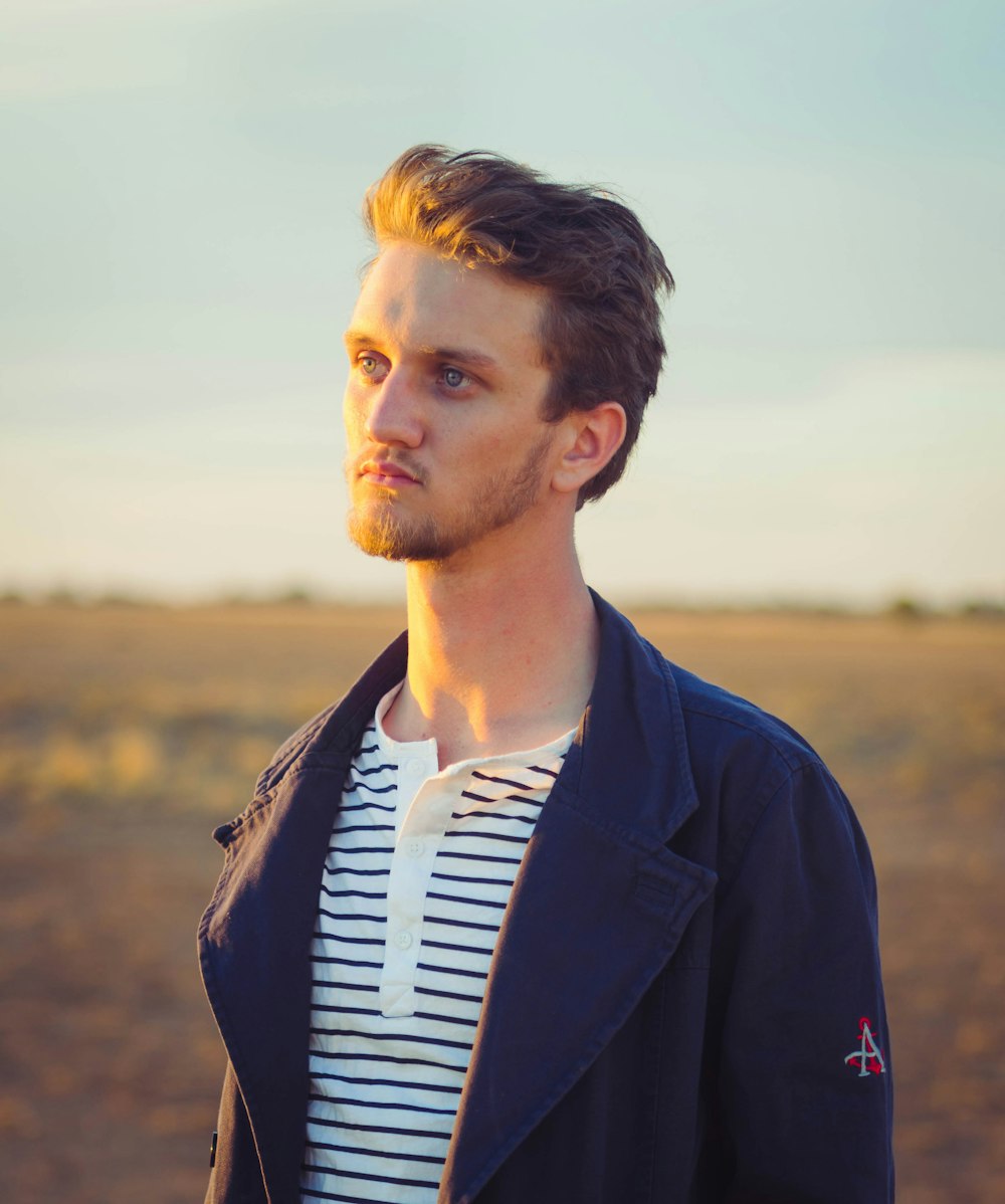 selective focus photo of man wearing blue topcoat