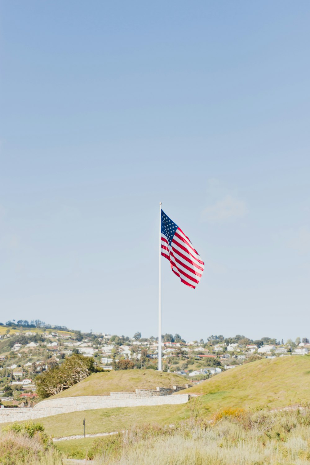 flag of USA near buildings during daytime