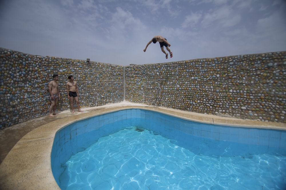 man jumping form fence