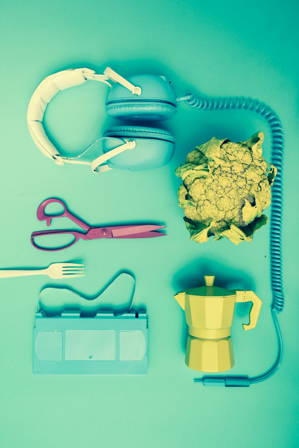 headset, scissor, teapot on table