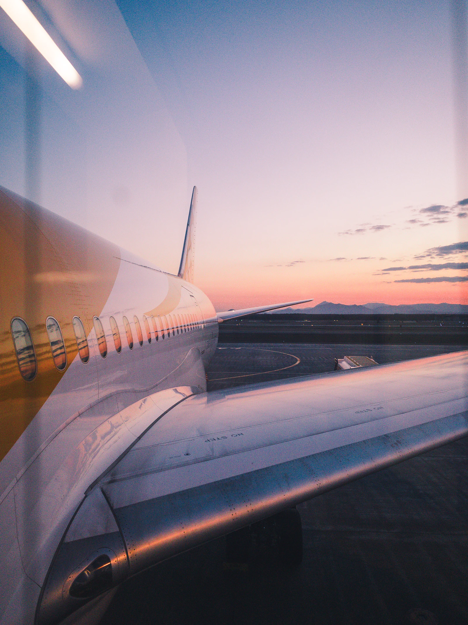 Wing tip above the clouds at sunset