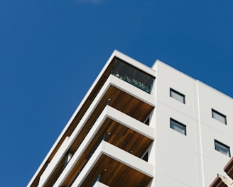 white concrete building with balconies during day
