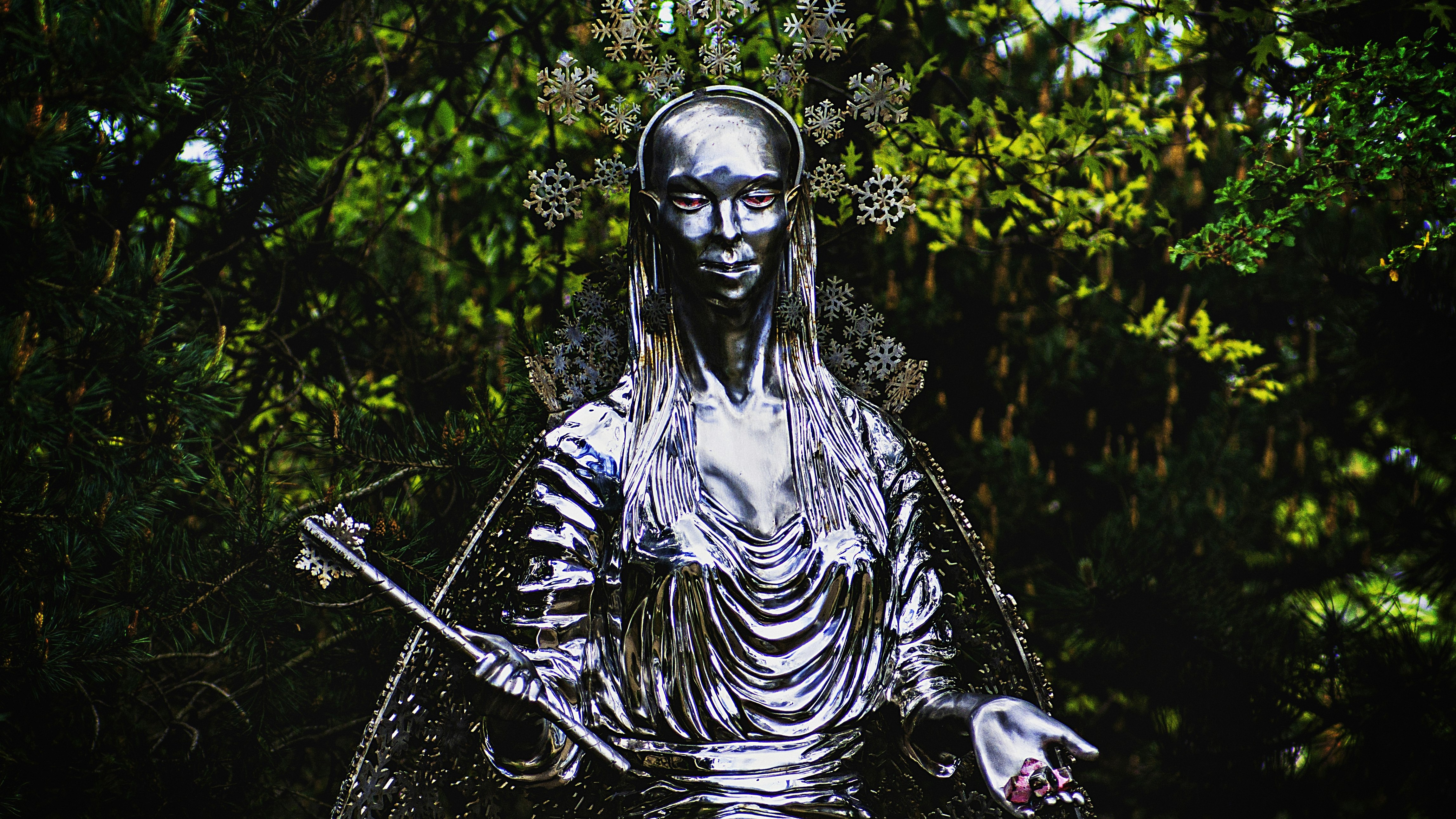 woman holding wand statue