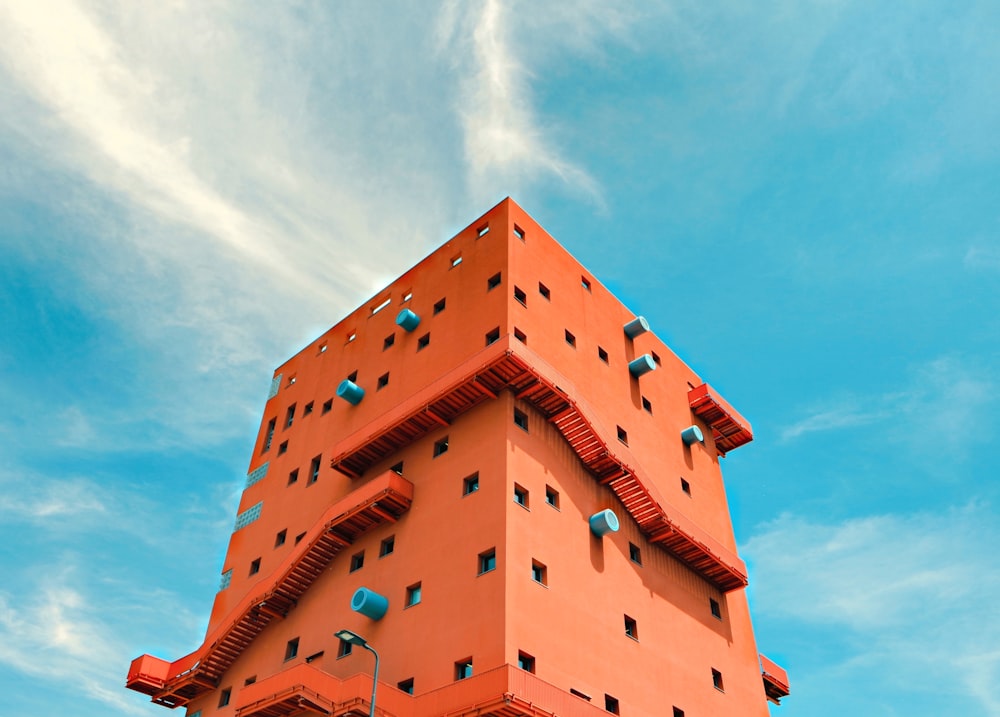 orange building with stairs and holes during day