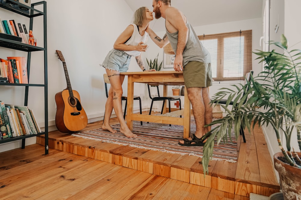 couple kissing near table in room