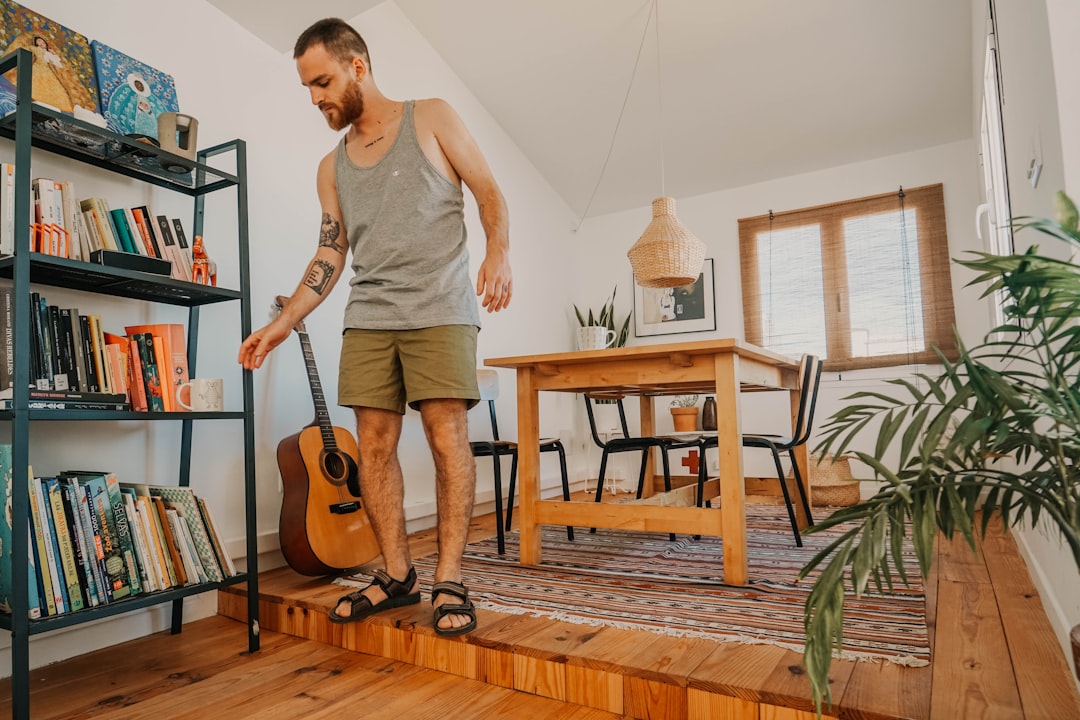 man standing near bookcase