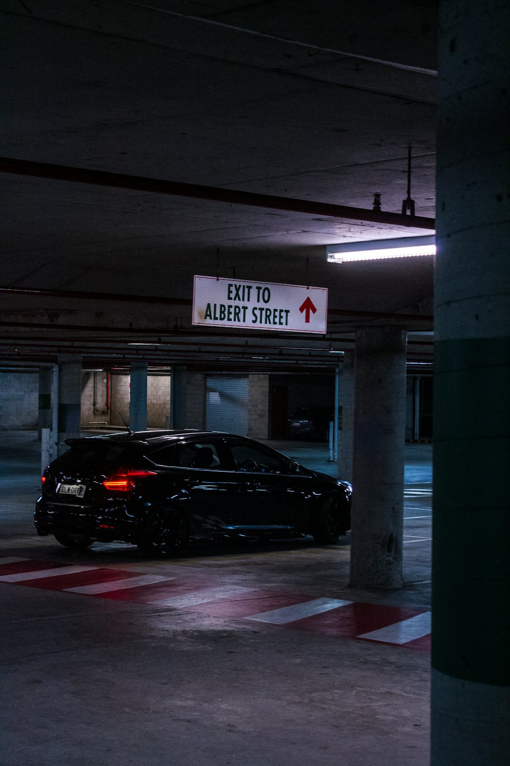 black car parked near gray concrete post