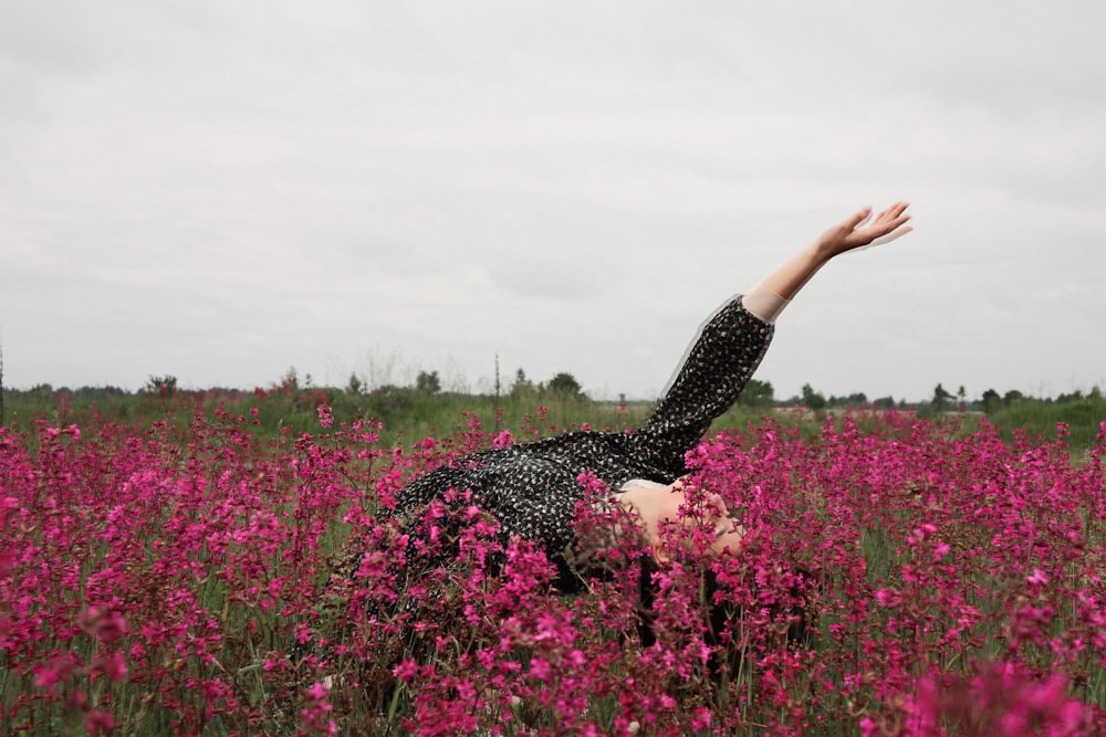 woman bending on flower field