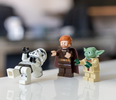 selective focus photo of Master Yoda, Kyro Ren, and Snow Tropper from Star Wars mini figures