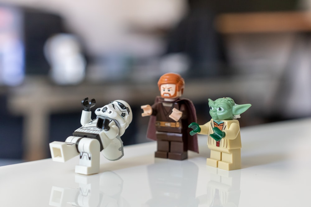 selective focus photo of Master Yoda, Kyro Ren, and Snow Tropper from Star Wars mini figures