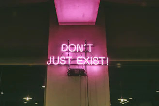 purple Don't Just Exist neon signage turned-on