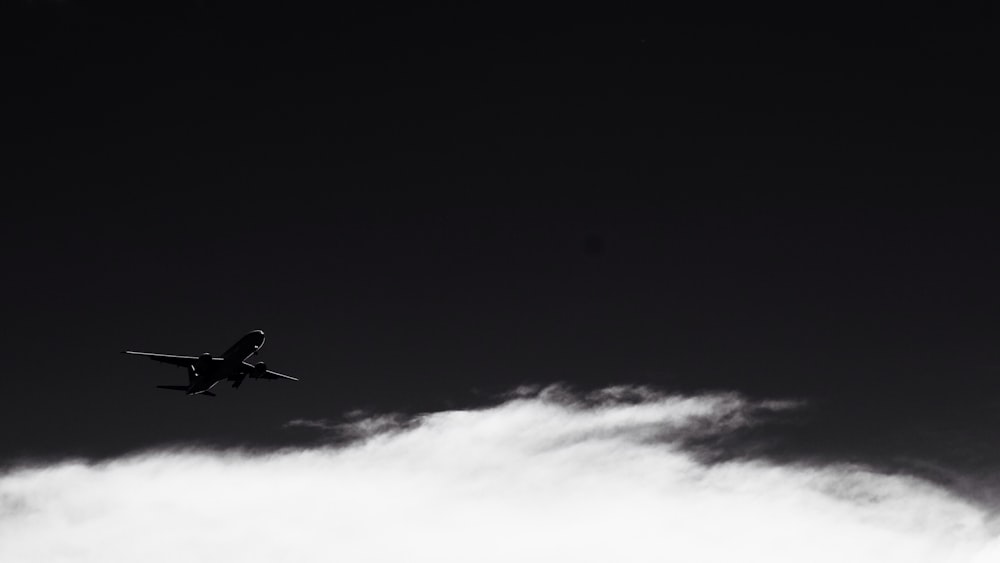 silhouette photo of flying plane