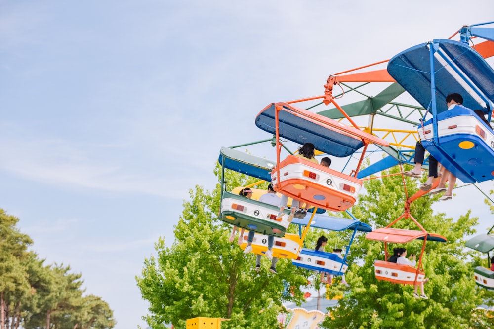 people riding carnival ride during daytime