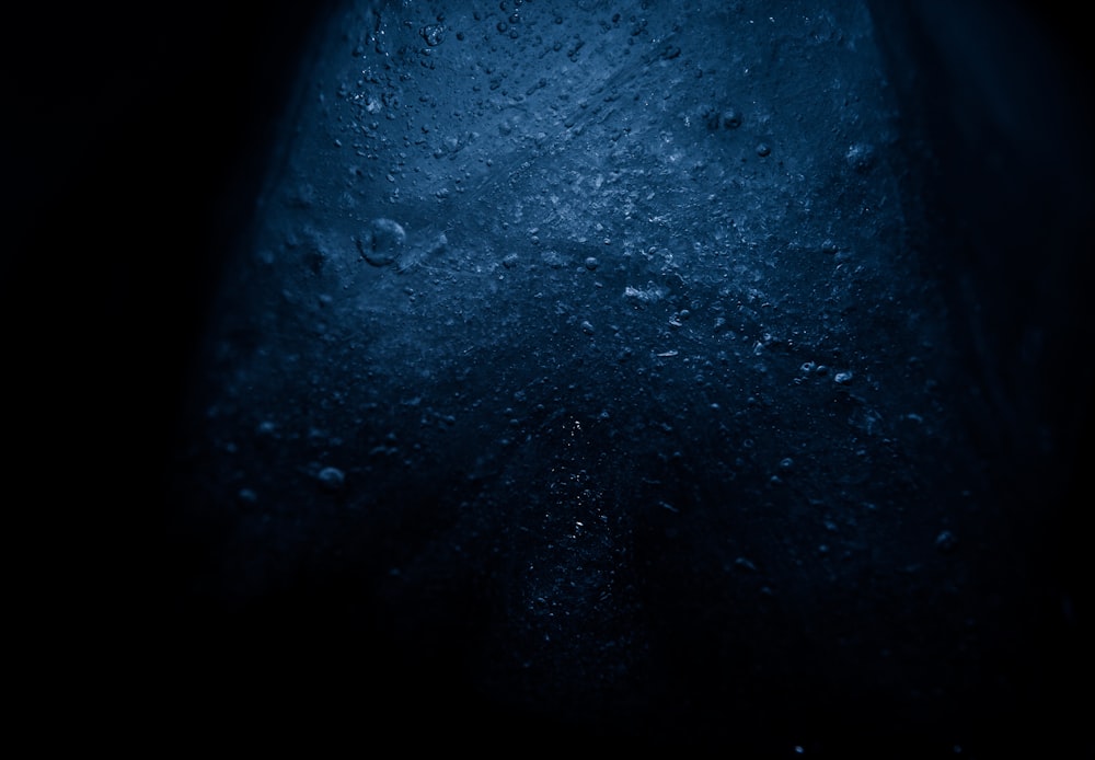 a dark blue background with water droplets