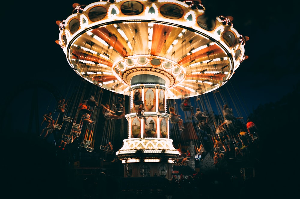 people riding revolving carnival ride during night