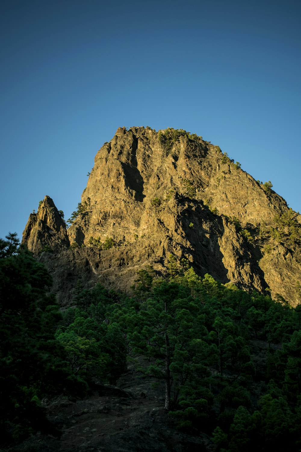 brown rocky mountain peak under clear blue sky