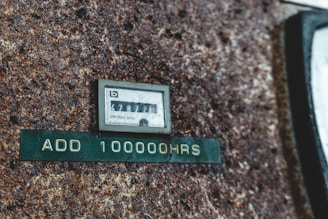 Close-up of a megohmmeter measuring electrical insulation resistance on industrial machinery.