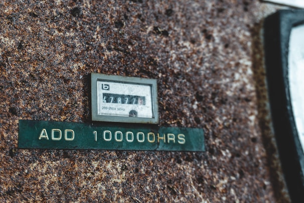Close-up of a megohmmeter measuring electrical insulation resistance on industrial machinery.