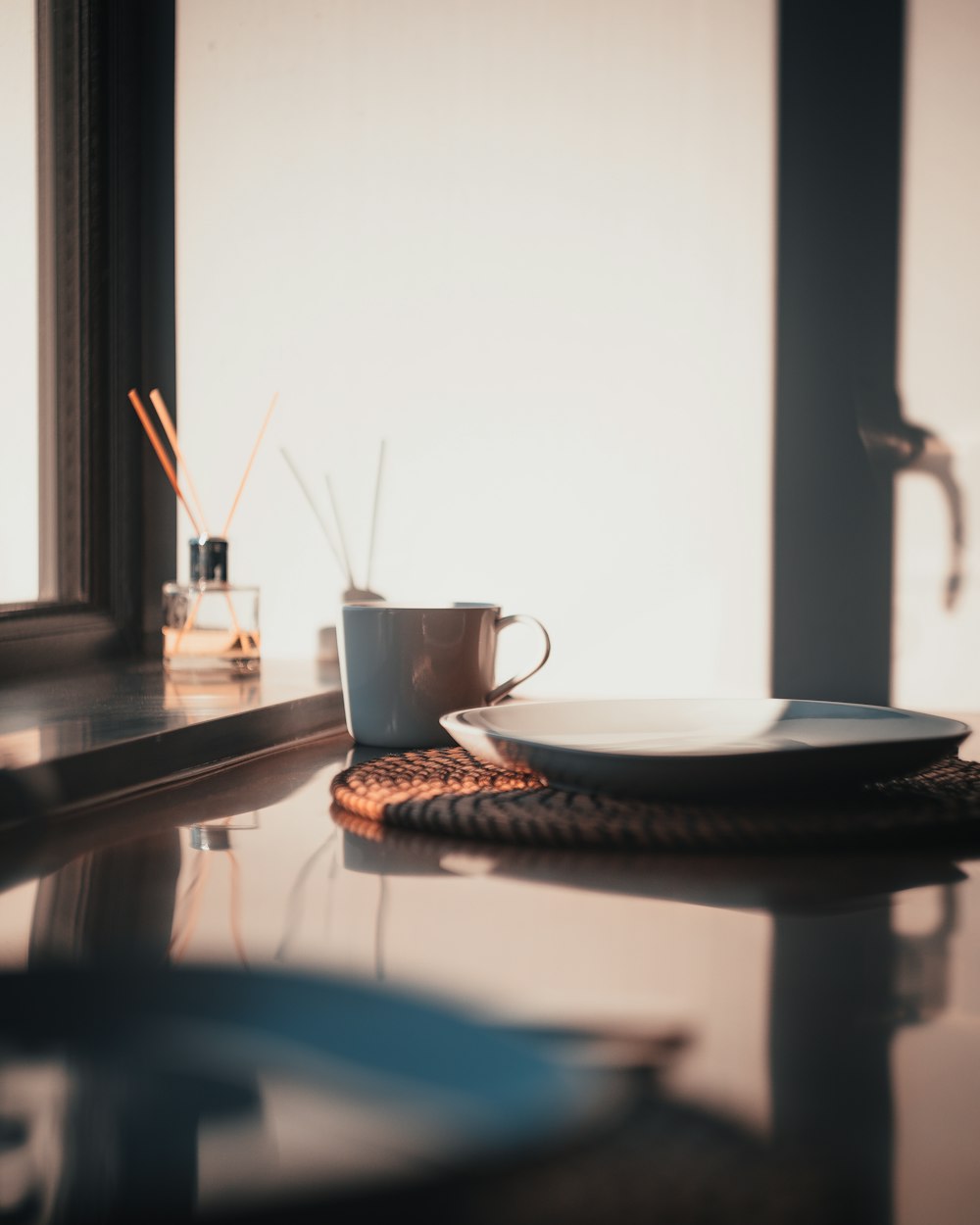 empty plate beside mug