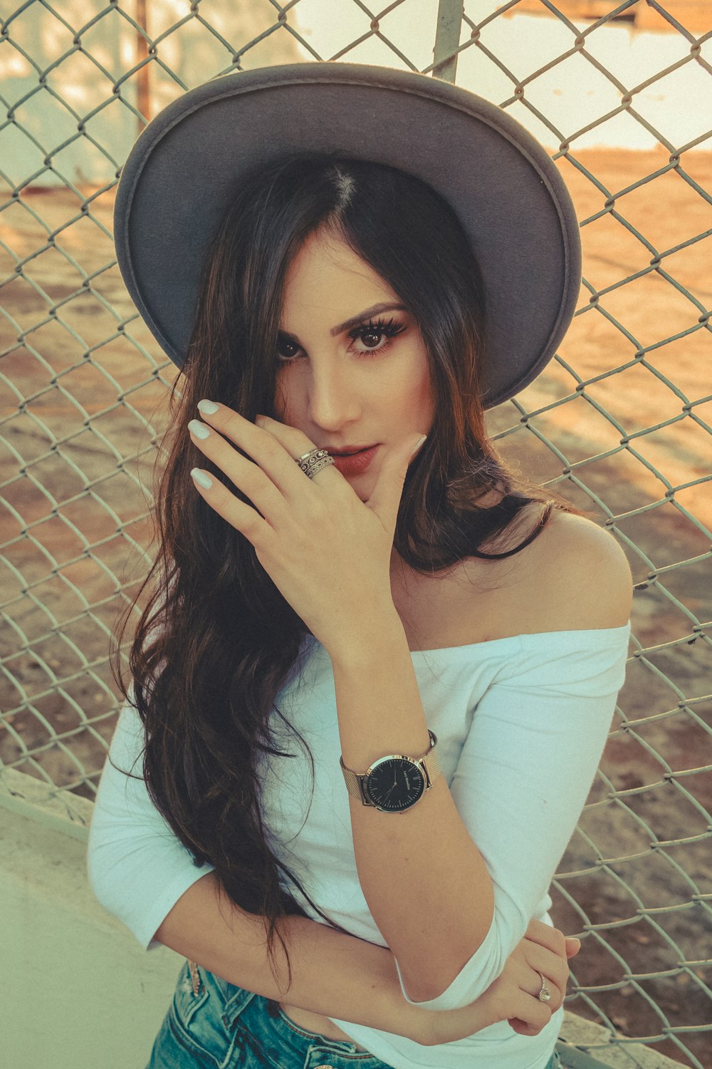 woman standing beside fence