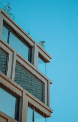 Modern restaurant facade with large windows and blue-white accents.