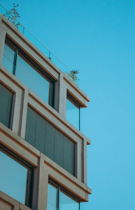 A modern exterior building facade featuring clean lines and deep blue accents.