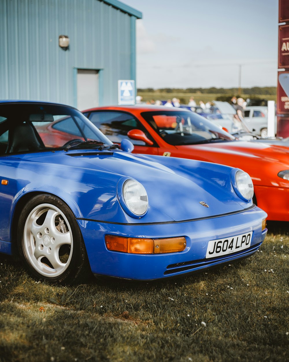 blue car near red car