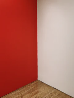 Before and after side-by-side of a Rochester living room transformed with fresh paint and new flooring