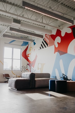 A modern living room wall featuring a colorful, detailed printed mural that blends seamlessly with the decor.