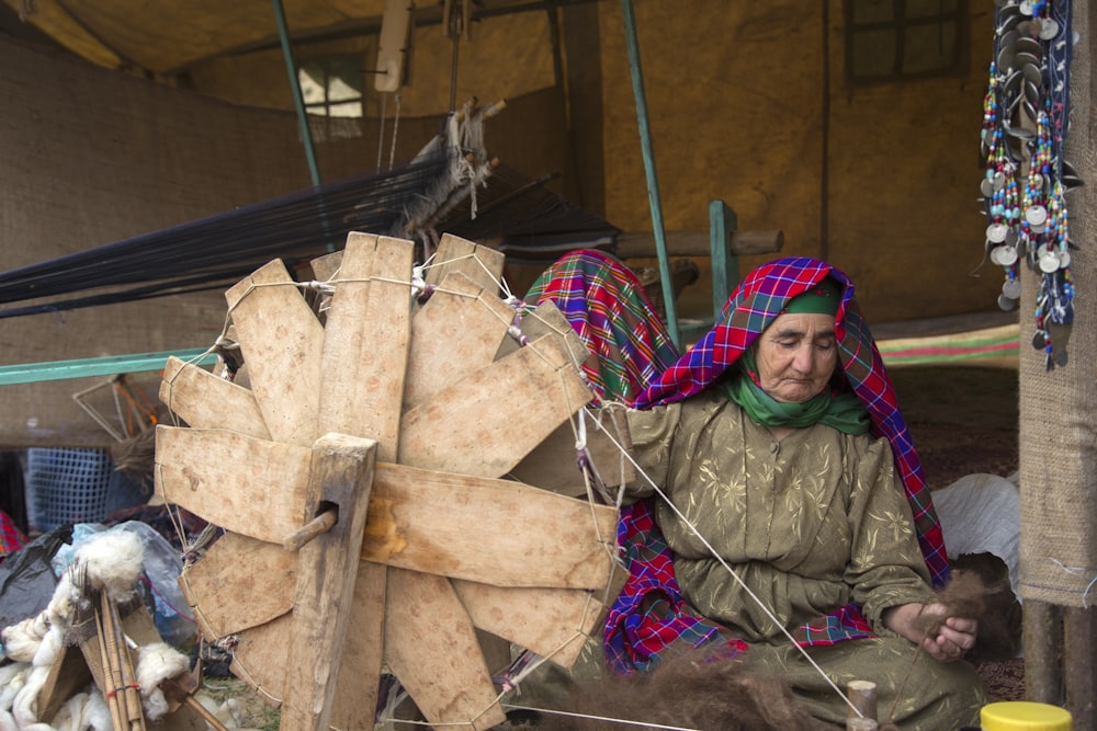 woman sitting beside brown fan