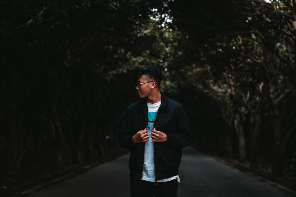 man standing on paved road