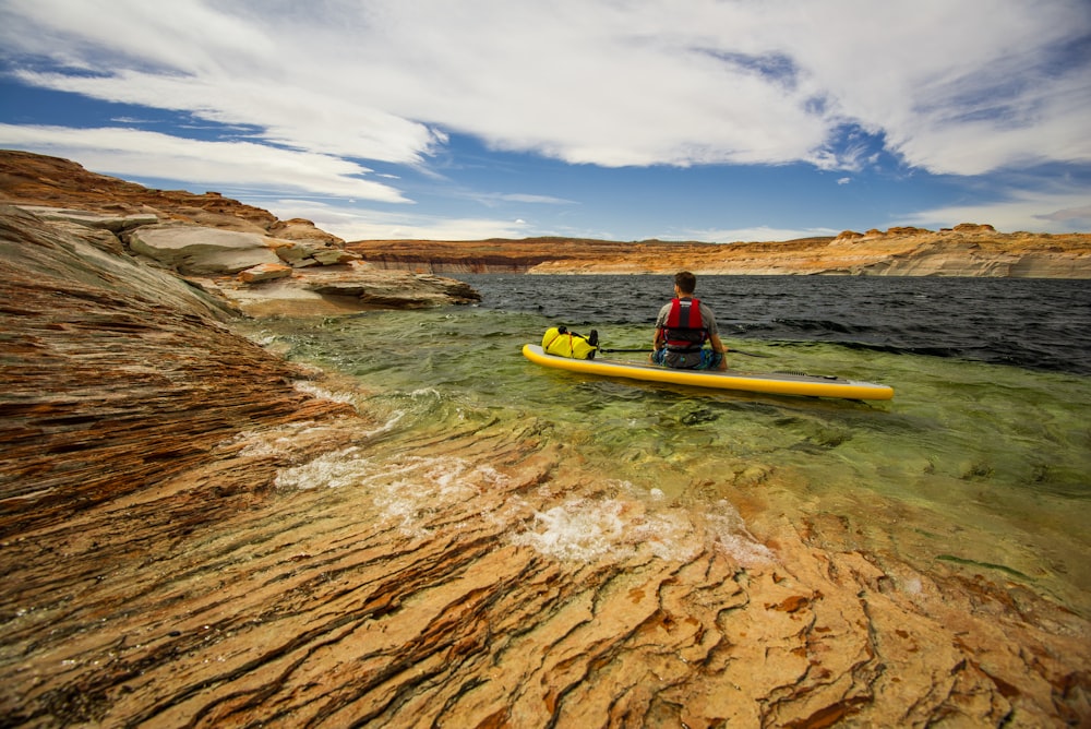 man sitting on surfboard