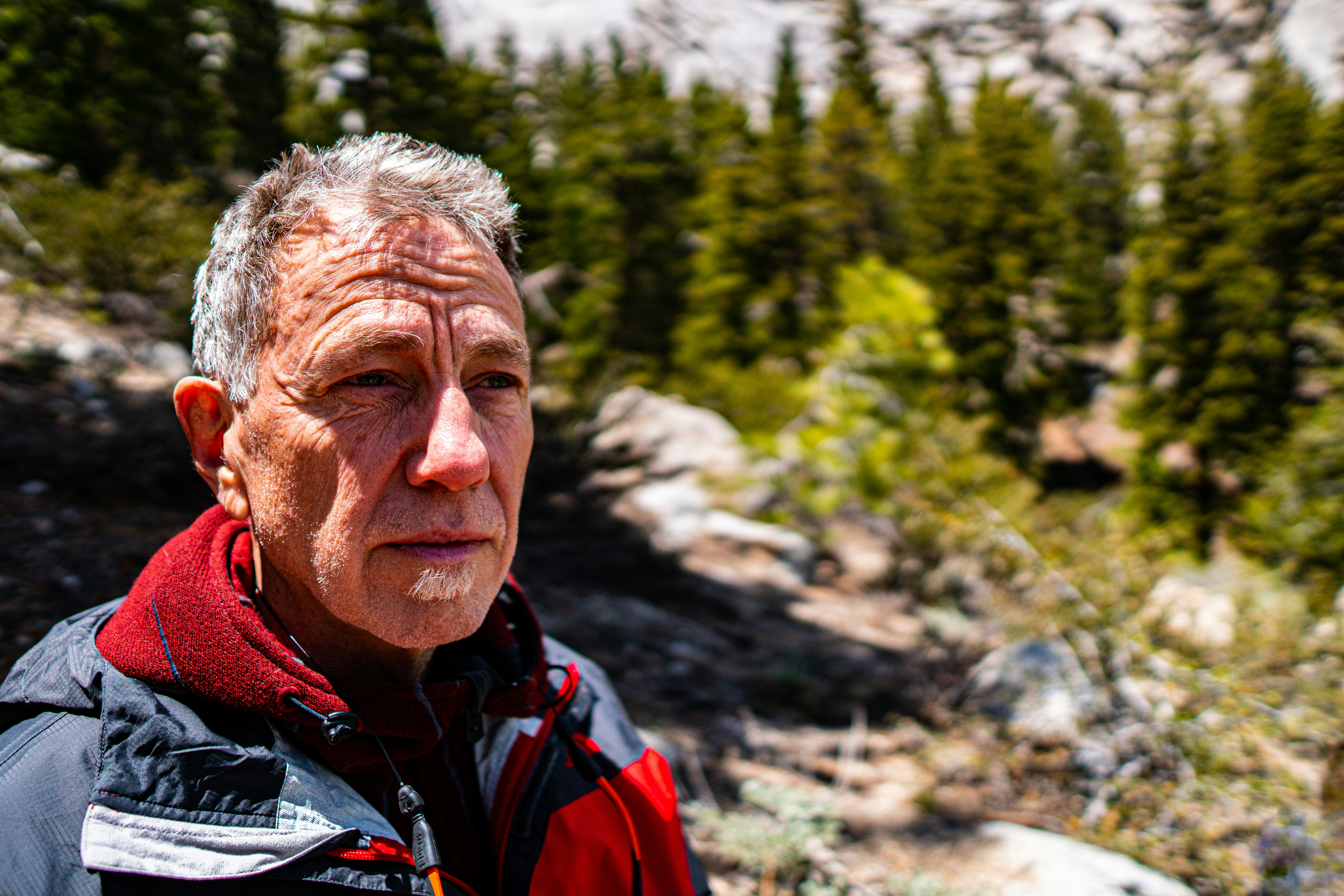 man wearing jacket on hill