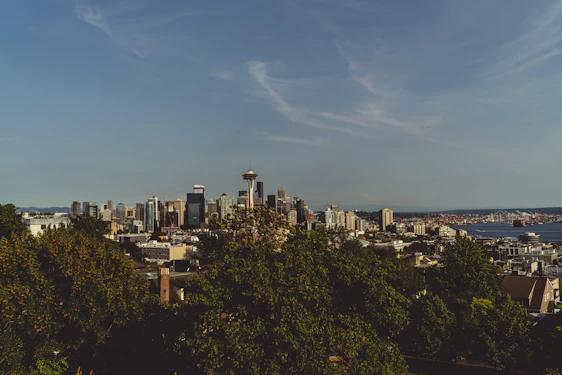 A group of engineers collaborating over blueprints with the Seattle skyline in the background.