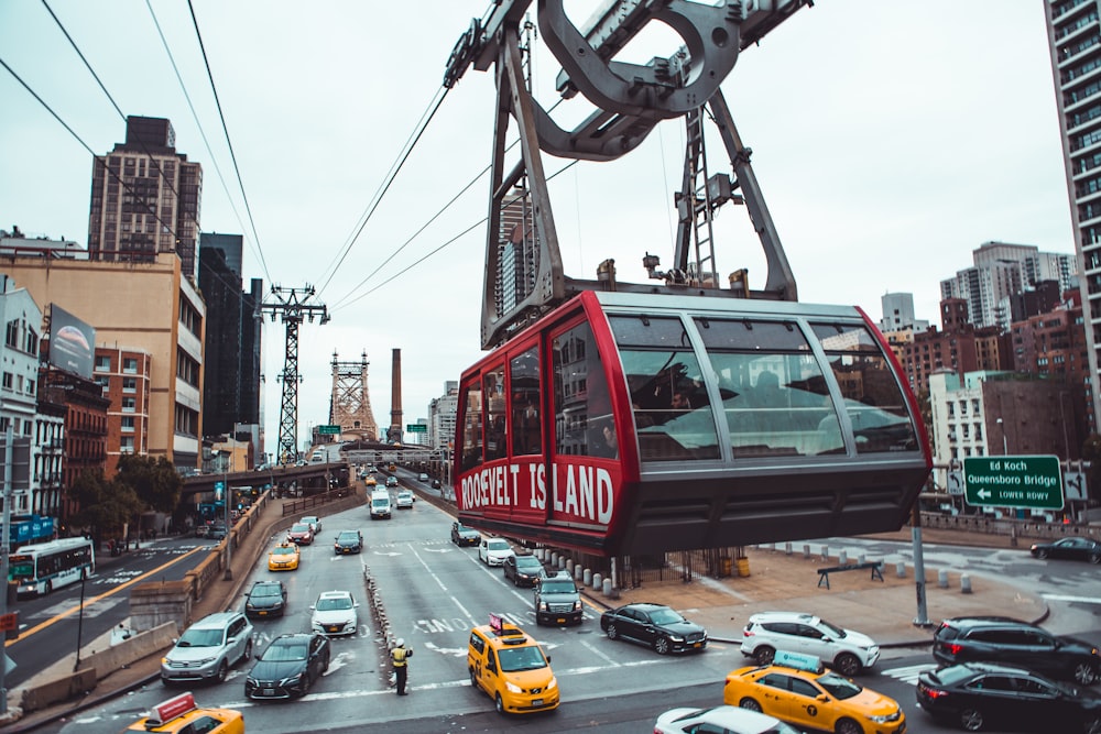 cable car above vehicles on crossing road