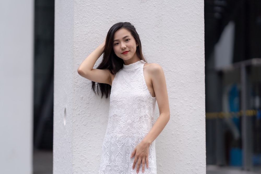 shallow focus photo of woman in white sleeveless dress