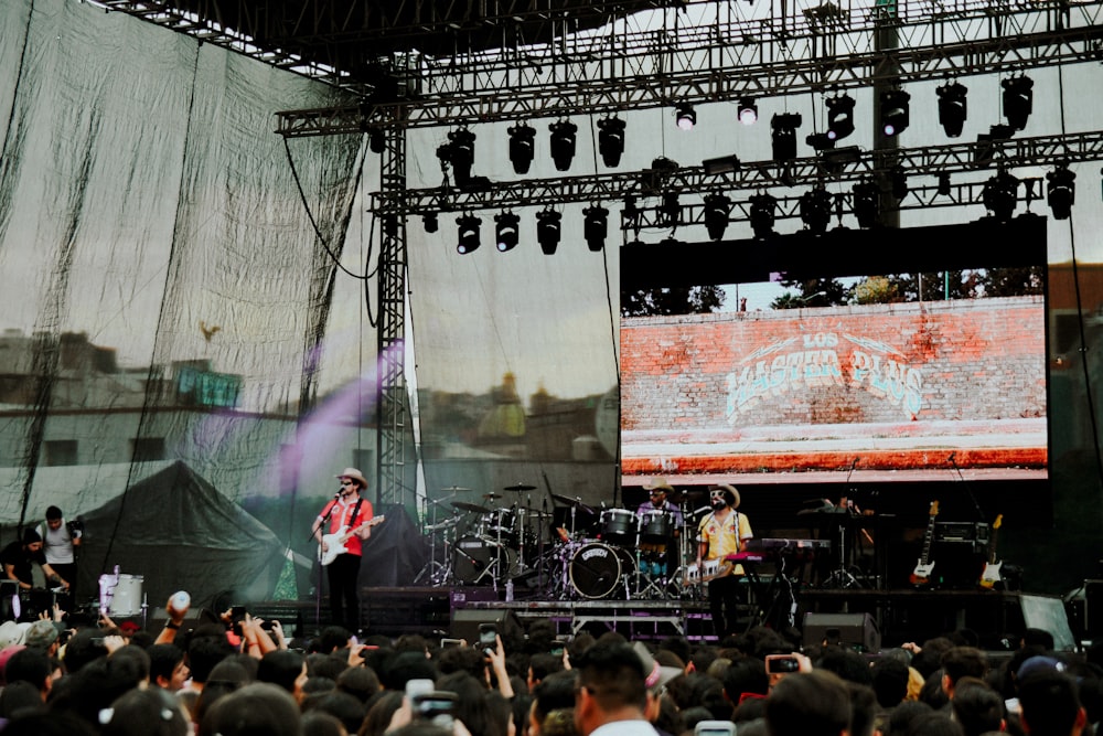 people watching on men performing on stage