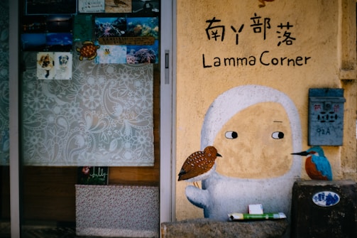 A colorful comic-style illustration of a friendly character holding a giant pencil next to a mailbox overflowing with letters.