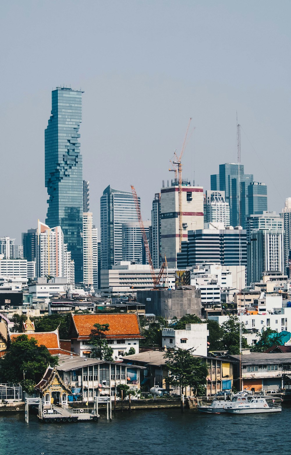 city buildings near body of water during daytime