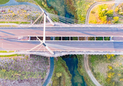 Aerial view of multiple modular bridges connecting rural areas surrounded by greenery.