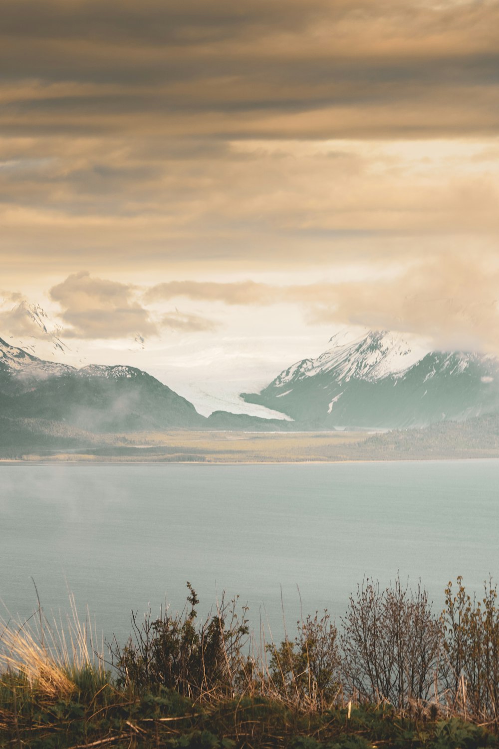 calm lake viewing mountain covered with snow