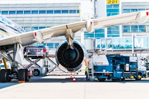 Fuel truck refueling a jet with precision and care at a busy airport